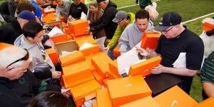 People hunting for their favorite pairs at a surplus shoe sale at the University of Oregon - Home of the Mighty Ducks